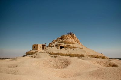 Scenic view of desert against clear sky