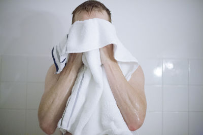 Midsection of man standing in bathroom