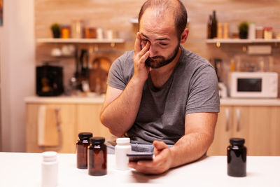 Side view of young man using phone