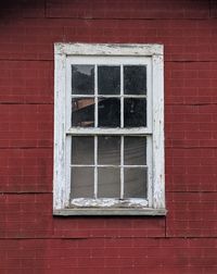 Low angle view of window on brick wall of building