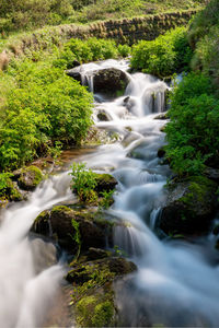 Long exposure of a waterfall flowing onto lee abbey beach in devon