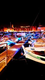 View of illuminated harbor at night