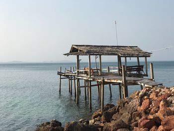 Pier on sea against clear sky