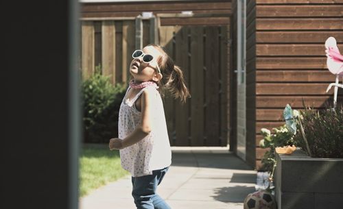 Young woman wearing sunglasses standing outdoors