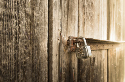Close-up of padlock on wooden door