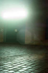 Illuminated building by street at night