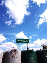 Low angle view of sign against sky