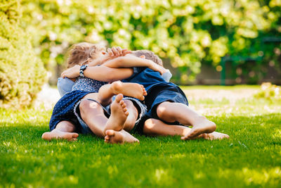 Rear view of father and son on grass