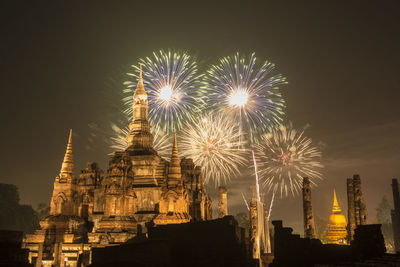 Low angle view of firework display against sky at night