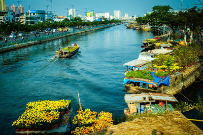 High angle view of boats moored on river in city