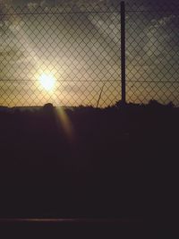 Sunset seen through chainlink fence