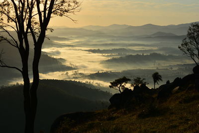 Scenic view of silhouette mountains against sky during sunset