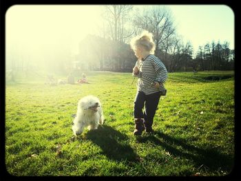 Girl playing on grassy field