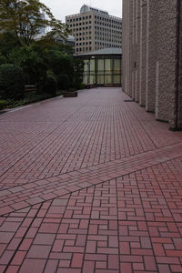 Surface level of footpath amidst buildings in city