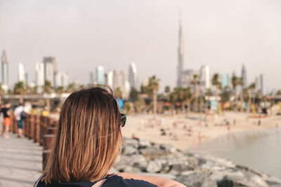 Portrait of woman looking at dubai skyline