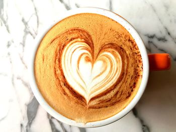 Directly above shot of cappuccino served on table