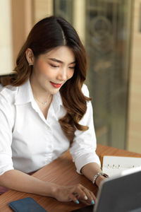 Woman working while sitting at cafe