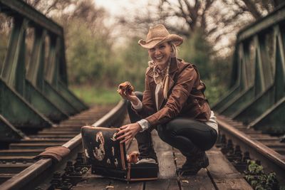Woman waiting on railroad track