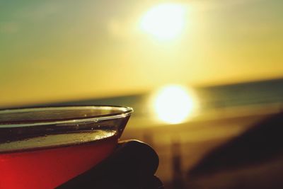 Close-up of hand on table at sunset