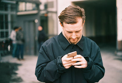 Man using mobile phone in city