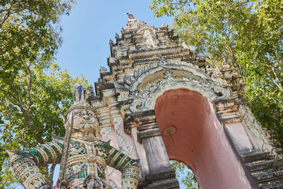 Low angle view of sculpture against building