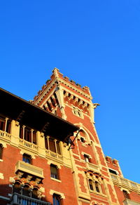 Low angle view of building against blue sky