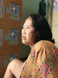 Portrait of woman looking away at home