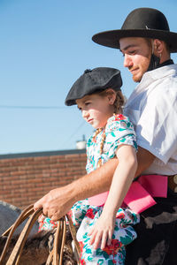 South american father and daughter in traditional festival