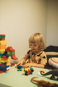 Girl playing with toy blocks