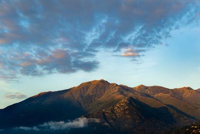 Scenic view of mountain against cloudy sky