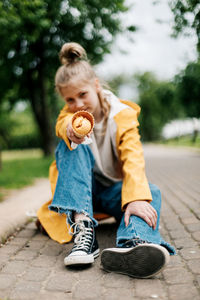 Full length of a boy sitting outdoors