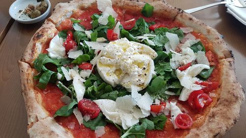 High angle view of pizza served on table