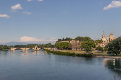 Arch bridge over river against sky