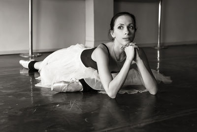 Portrait of woman sitting on floor at home