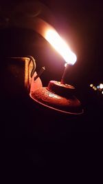 Close-up of illuminated lamp against black background