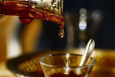 Close-up of coffee pouring in glass