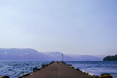 Pier over sea against sky