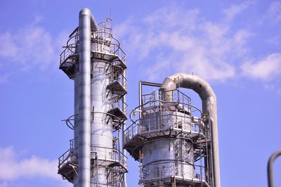 Low angle view of smoke stack against sky