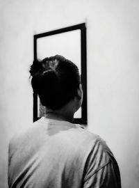 Rear view of man looking at home
