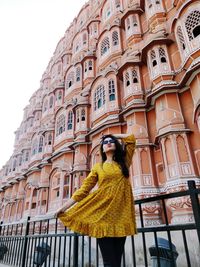 Young woman standing outside historic building