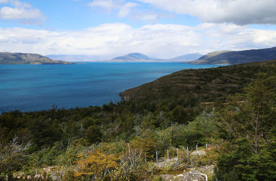 Scenic view of sea and mountains against sky