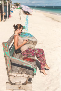 Young man sitting on beach