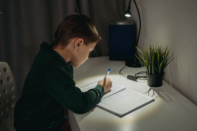 Side view of man working at office