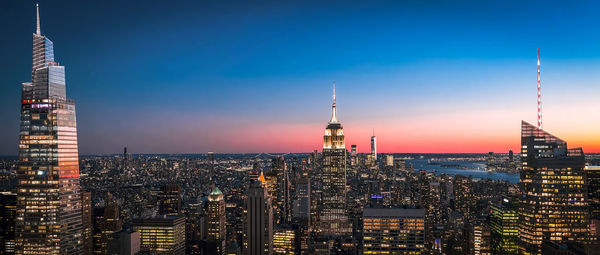 Illuminated cityscape against sky at sunset.new york city, united states of america