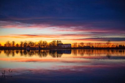 Scenic view of lake against orange sky