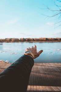 Man on lake against sky