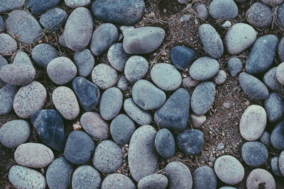 High angle view of pebbles on sand