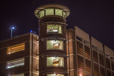 Low angle view of illuminated building against sky at night