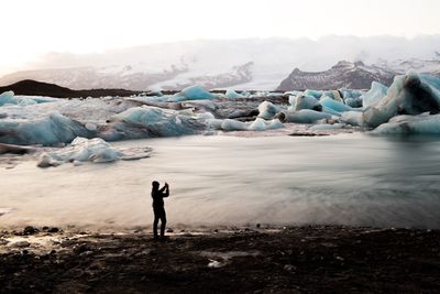 Scenic view of frozen landscape against sky