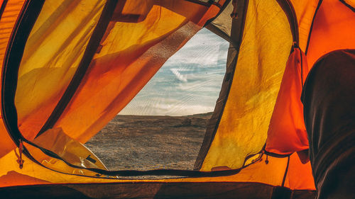 Tilt image of tent against sky seen through window